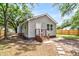 Exterior view of a charming home featuring gray siding, a porch with wooden stairs, and stone pathway at 2678 Ranger Dr, North Charleston, SC 29405