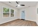 Bright living room with a ceiling fan, wood-look flooring, and a light blue entryway door at 2678 Ranger Dr, North Charleston, SC 29405