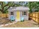 Charming back house with a yellow door and shutters, complemented by cozy outdoor chairs at 2678 Ranger Dr, North Charleston, SC 29405