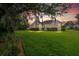 Beautiful backyard with lush green grass and mature trees at sunset at 2772 Latrobe Ct, Mount Pleasant, SC 29466