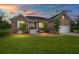 Charming brick home with manicured lawn, and a driveway leading to the attached garage in a well-lit setting at 2772 Latrobe Ct, Mount Pleasant, SC 29466