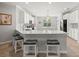 Open kitchen with white cabinets, quartz countertops, stainless appliances, and breakfast bar at 2772 Latrobe Ct, Mount Pleasant, SC 29466