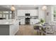Bright kitchen with white cabinets, stainless appliances, tile backsplash, and adjacent dining area at 2772 Latrobe Ct, Mount Pleasant, SC 29466