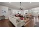 Spacious living room with hardwood floors, a ceiling fan, and access to the kitchen and front entry at 2772 Latrobe Ct, Mount Pleasant, SC 29466