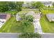 Aerial view showcases the home's landscaped yard, mature shade tree, and convenient two-car garage in a peaceful neighborhood setting at 2912 Doncaster Dr, Charleston, SC 29414