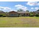 Spacious backyard with a neatly maintained lawn and screened-in porch provides ample space for outdoor enjoyment and entertaining at 2912 Doncaster Dr, Charleston, SC 29414