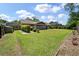 Expansive backyard showcasing lush green lawn with trimmed hedges and brick-lined garden beds, perfect for outdoor activities and landscaping at 2912 Doncaster Dr, Charleston, SC 29414