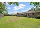 Expansive backyard showcasing a lush green lawn, mature trees, and a screened porch, perfect for outdoor activities and serene relaxation at 2912 Doncaster Dr, Charleston, SC 29414