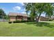 This brick home with mature trees on a well-maintained lawn offers great curb appeal in a serene setting at 2912 Doncaster Dr, Charleston, SC 29414