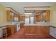 Traditional kitchen with laminate counters, white appliances, a breakfast bar, and wood look floors at 2912 Doncaster Dr, Charleston, SC 29414