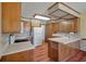 Traditional eat-in kitchen with wood cabinets, laminate counters, and wood-look floors at 2912 Doncaster Dr, Charleston, SC 29414
