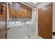 A compact laundry room with a washer, dryer, overhead cabinets, and linoleum flooring at 2912 Doncaster Dr, Charleston, SC 29414