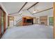 Expansive living room with vaulted ceilings, brick fireplace, built-in shelving and views of dining area and staircase at 2912 Doncaster Dr, Charleston, SC 29414