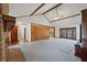 Open-concept living room with brick fireplace, hardwood floors, and access to back patio, laundry room, and kitchen at 2912 Doncaster Dr, Charleston, SC 29414