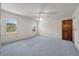 Spacious main bedroom featuring neutral carpet, ceiling fan, and two windows for natural light at 2912 Doncaster Dr, Charleston, SC 29414