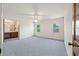Spacious main bedroom featuring neutral carpet, ceiling fan, and adjacent vanity at 2912 Doncaster Dr, Charleston, SC 29414