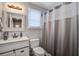 Clean bathroom with a white vanity, neutral walls, and a shower curtain in a relaxing color scheme at 2916 Shadow Ln, North Charleston, SC 29406