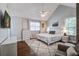 Cozy bedroom featuring a ceiling fan, large windows, and a plush rug over hardwood floors at 2916 Shadow Ln, North Charleston, SC 29406