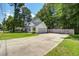 Spacious driveway leading to a well-maintained home with an attached garage and fenced backyard at 2916 Shadow Ln, North Charleston, SC 29406
