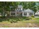 Charming two-story home with a landscaped yard, inviting front porch, and classic black shutters at 2916 Shadow Ln, North Charleston, SC 29406