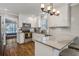 Bright kitchen with stainless steel appliances, white cabinets, granite counters, and hardwood floors at 2916 Shadow Ln, North Charleston, SC 29406