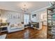 Cozy living room featuring hardwood floors, stylish decor, and natural light streaming through the windows at 2916 Shadow Ln, North Charleston, SC 29406