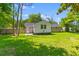 Expansive backyard featuring lush green grass and partial shade from mature trees at 300 Oklahoma Pl, Ladson, SC 29456