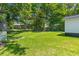 Spacious backyard featuring lush green grass and mature trees at 300 Oklahoma Pl, Ladson, SC 29456