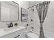 Updated bathroom featuring a tub/shower, elegant tile, and a marble-topped vanity at 300 Oklahoma Pl, Ladson, SC 29456