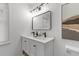 Elegant bathroom featuring double sinks, modern faucets, black mirror and a view of the shower at 300 Oklahoma Pl, Ladson, SC 29456
