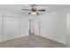 Spacious bedroom with neutral carpet, white walls, ceiling fan, and closet doors at 300 Oklahoma Pl, Ladson, SC 29456