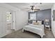 Cozy bedroom featuring a bed with nightstands, modern ceiling fan and view of the entry at 300 Oklahoma Pl, Ladson, SC 29456