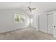 Cozy bedroom with neutral carpet, white walls, a ceiling fan, and backyard access at 300 Oklahoma Pl, Ladson, SC 29456