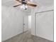 Spacious bedroom with neutral carpet, white walls, ceiling fan, and closet doors at 300 Oklahoma Pl, Ladson, SC 29456