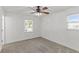 Bright bedroom with neutral carpet and walls, with a ceiling fan and two windows at 300 Oklahoma Pl, Ladson, SC 29456