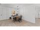 Bright dining area with a round wooden table, black chairs, and a modern chandelier at 300 Oklahoma Pl, Ladson, SC 29456