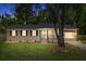 Inviting home with a combination brick facade and lush front yard, illuminated by warm outdoor lighting at 300 Oklahoma Pl, Ladson, SC 29456