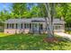 Charming brick home featuring black shutters, a teal front door, and a well-manicured lawn at 300 Oklahoma Pl, Ladson, SC 29456