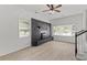 Open-concept living area with a modern fireplace, large windows, and neutral flooring at 300 Oklahoma Pl, Ladson, SC 29456