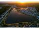 Stunning aerial view of a Primary planned community on a lake with a beautiful sunset at 3046 Sweetleaf Ln, Johns Island, SC 29455