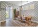 Modern dining area with plenty of natural light and hardwood flooring at 3046 Sweetleaf Ln, Johns Island, SC 29455
