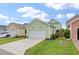 Charming home with a two-car garage, well-maintained lawn, and inviting curb appeal at 3046 Sweetleaf Ln, Johns Island, SC 29455