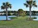 Scenic lake view with an island, palm trees, and a tranquil blue hammock visible in the distance at 3046 Sweetleaf Ln, Johns Island, SC 29455