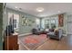 Inviting living room with a comfortable sectional sofa, large windows, and stylish decor for relaxation at 3046 Sweetleaf Ln, Johns Island, SC 29455