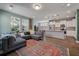 Spacious living area with kitchen view, featuring a cozy sectional, modern lighting, and open design at 3046 Sweetleaf Ln, Johns Island, SC 29455