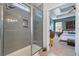 Modern tiled shower with a built-in niche and glass door is conveniently located next to the bedroom at 3046 Sweetleaf Ln, Johns Island, SC 29455