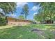 Spacious backyard featuring a well-maintained lawn, brick house, and mature trees at 308 Ashley Dr, Summerville, SC 29485