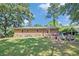 Outdoor patio area with grill, chairs, and a grassy area at 308 Ashley Dr, Summerville, SC 29485