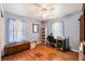 This cozy bedroom features hardwood floors, two windows, and a ceiling fan with a light at 308 Ashley Dr, Summerville, SC 29485