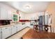 Efficient kitchen featuring white cabinetry, stainless steel appliances, and a dining area at 308 Ashley Dr, Summerville, SC 29485